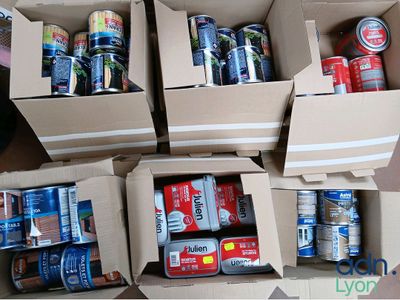 several boxes of cans of soda and cans of soda sitting on a table