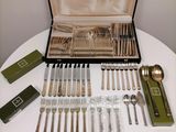 a table with silverware on it and a case full of silverware