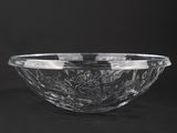 a clear glass bowl sitting on top of a black table