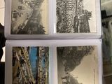 a person holding a bunch of postcards in their hand