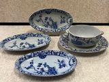 three blue and white plates and a bowl on a counter