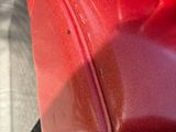 a close up of a red bag on the ground