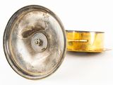a metal object that is sitting on a white surface