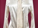 shirt and tie on a mannequin stand against a red background