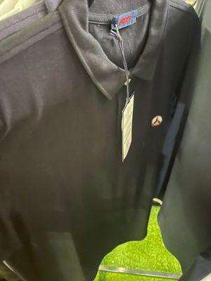 a black shirt with a banana on it hanging on a hanger