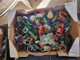 a cardboard box filled with assorted toys and electronics
