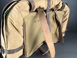 duffel bag with leather straps on a grey background