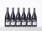 six bottles of red wine lined up in a row