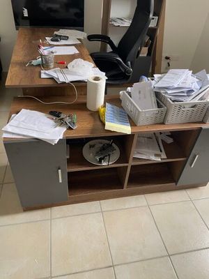 a desk with a chair and a computer on it