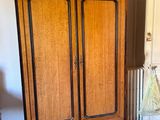 a wooden cabinet in the corner of a room
