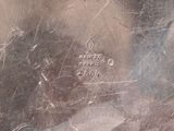 a close up of a silver plate with writing on it