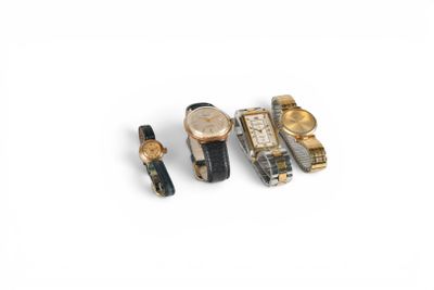 three watches and a watch band are sitting on a white surface