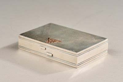 a silver box sitting on top of a white table