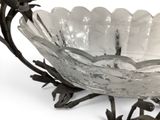 a glass bowl that is sitting on a metal stand