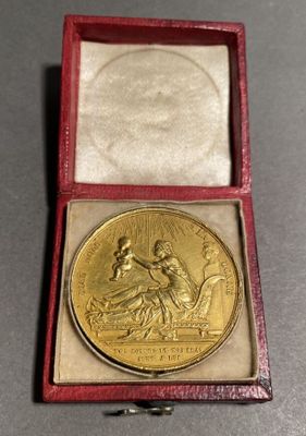 an image of a gold medal in a red case