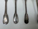 five spoons that are sitting next to each other on a table