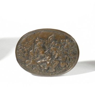 a small bronze coin sitting on a white surface
