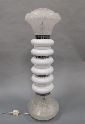 a white lamp that is sitting on a table