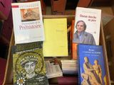 many books in a box on a table
