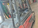 a red forklift truck parked in a warehouse