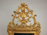 a mirror with a gold frame on a wall