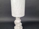 a white table lamp with a white shade on it