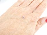 a woman ' s hand with a diamond ring on it