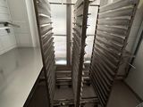 an image of a kitchen with a bunch of trays of food in it