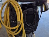 a hose attached to a machine in a garage