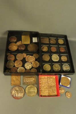 a box of coins sitting on a table next to a box of coins