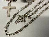 a silver cross and a chain with a cross on it