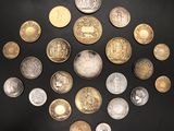 many coins arranged in a circle on a black surface