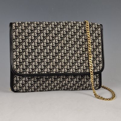 a black and white bag with a gold chain strap