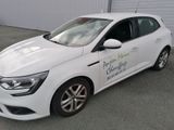 a picture of a white car parked in front of a garage