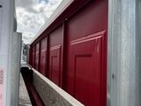 a close up of a red building with a sign on it
