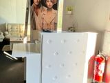 a white refrigerator with a picture on it in a living room