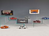 several toy cars are on display in a glass display case