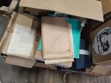 a box full of books and papers on the floor