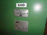 a green machine with a metal plate on it