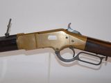 an old rifle with a wooden handle on a white surface