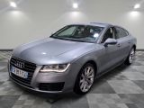 the audi is parked in a large room with a checkered floor
