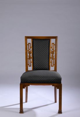 an image of a chair with a patterned back and a wooden frame