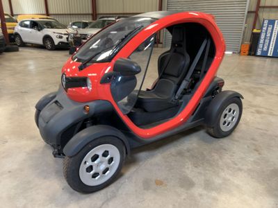a small red car that is parked in a garage