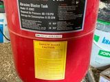a red fire extinguisor sitting on the ground