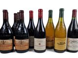 several bottles of wine are lined up on a white surface