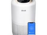 a white air purifier next to a smart phone