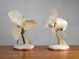two white and red fan on a wooden table
