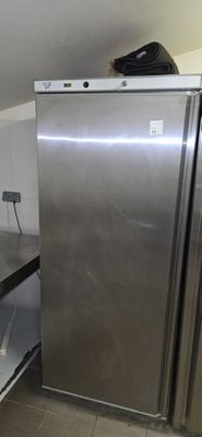 a silver refrigerator in the corner of a kitchen