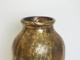a vase that is sitting on a table with a white background