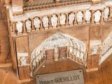 a wooden model of a building with a plaque on it